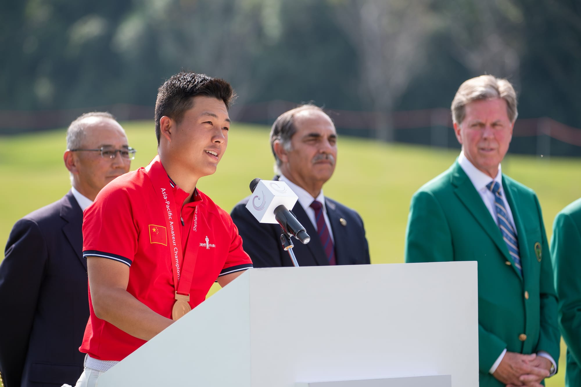 Kei Muratsu, Taimur Hassan Amin and Fred Ridley listen to Lin Yuxin's victory speech.