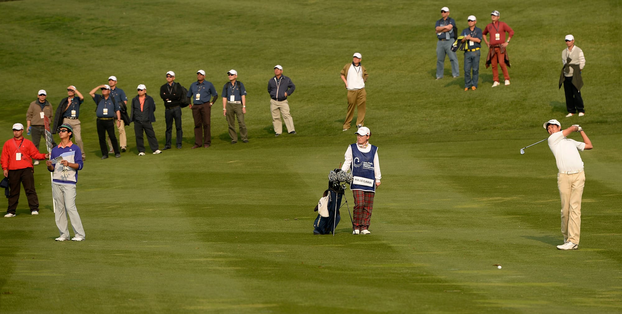 With playing partner Dou Zecheng watching on, runner-up Shohei Hasegawa strikes an approach shot during the final round.