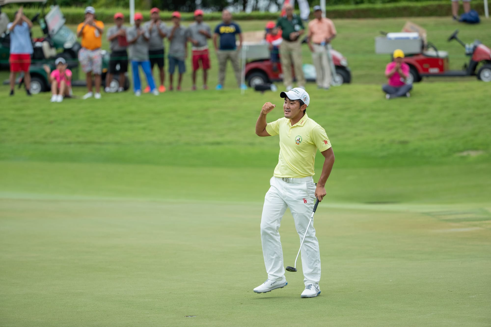 Takumi Kanaya reacts after holing a long putt.