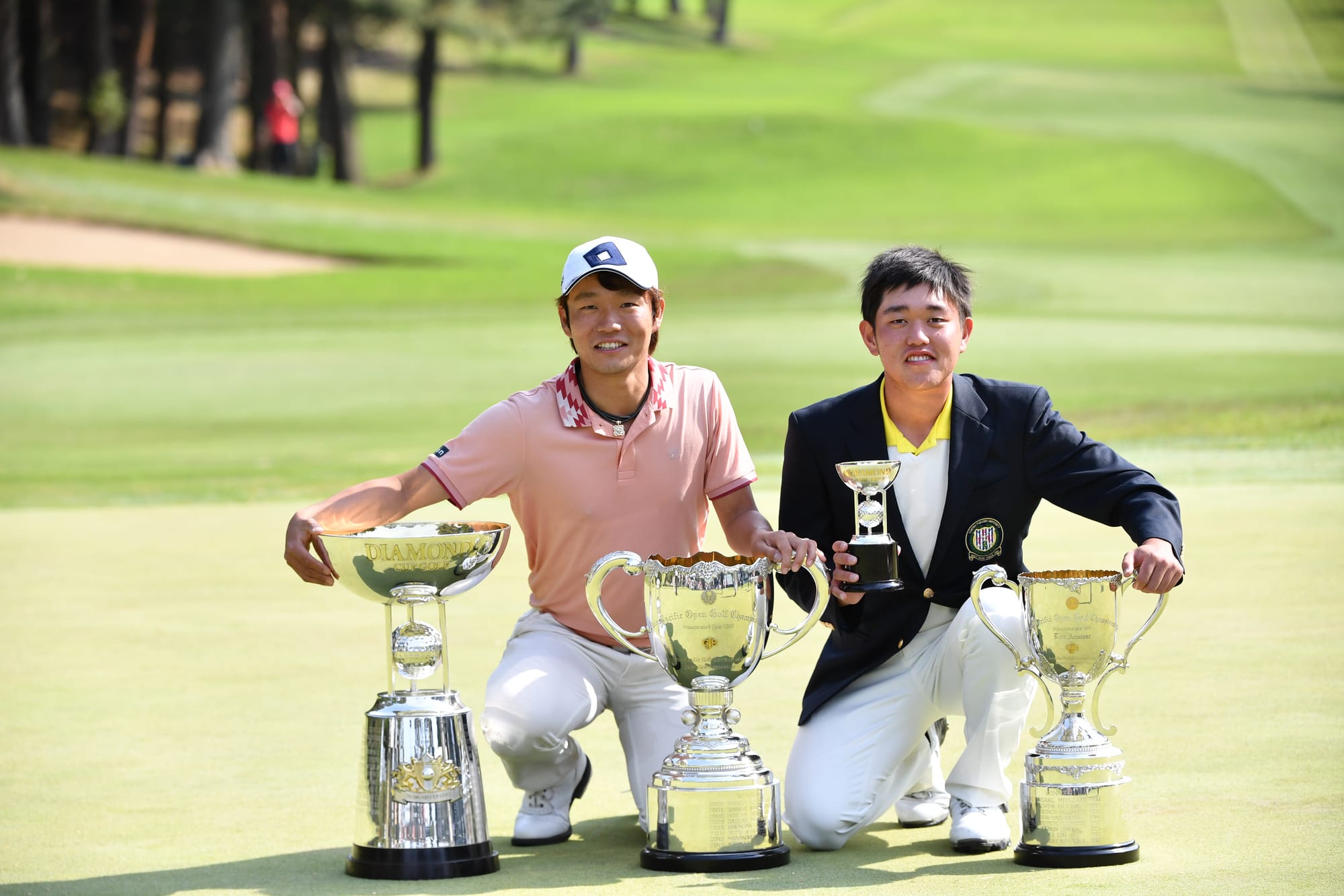 Champion Yosuke Asaji and low amateur Ren Yonezawa show off the silverware they won.