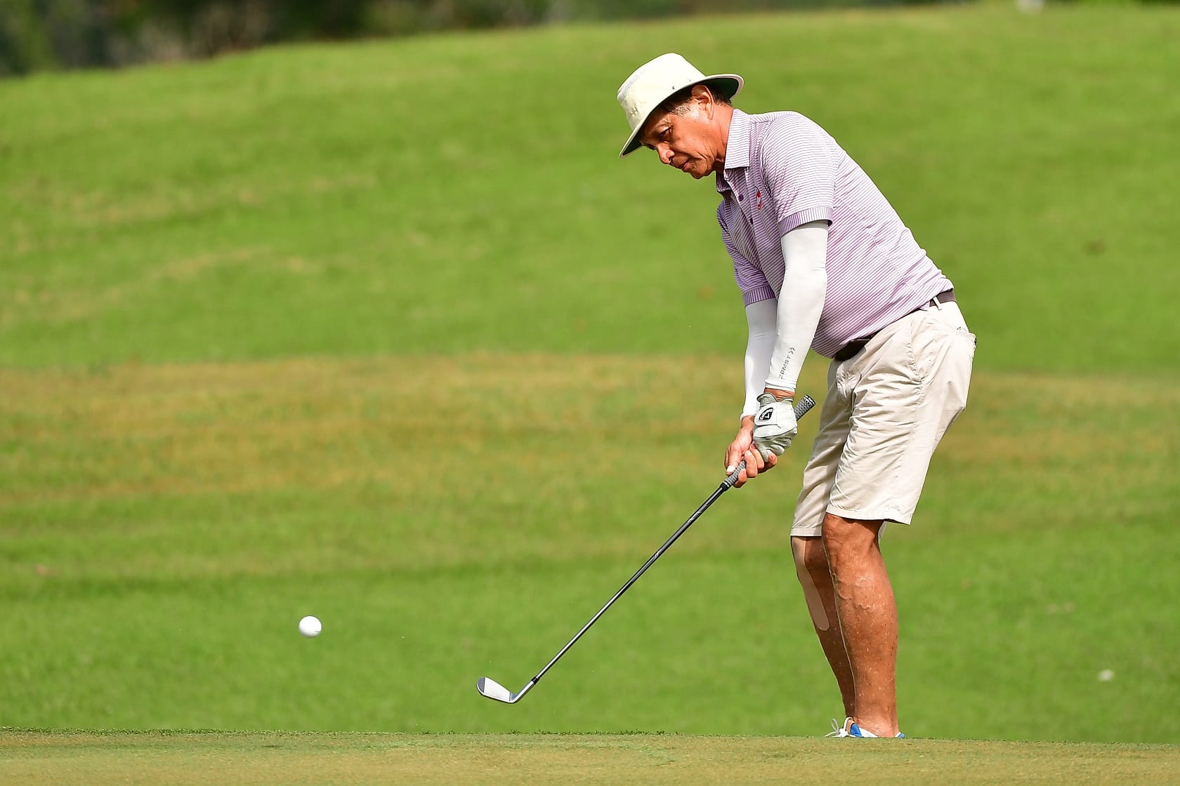 Singaporean Douglas Ooi is a study in concentration as he executes a delicate chip.