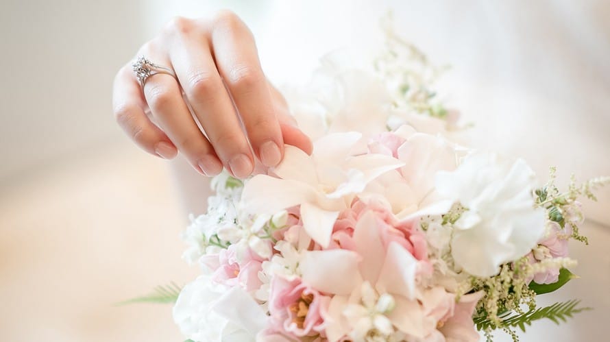 Pale pink natural wedding manicure on bride's hands