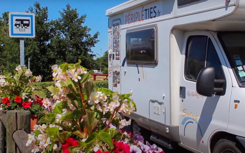 Motorhome aire sign in France with a motorhome parked behind