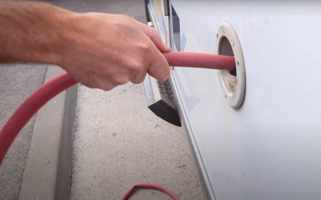 Hose filling the fresh water tank of a motorhome