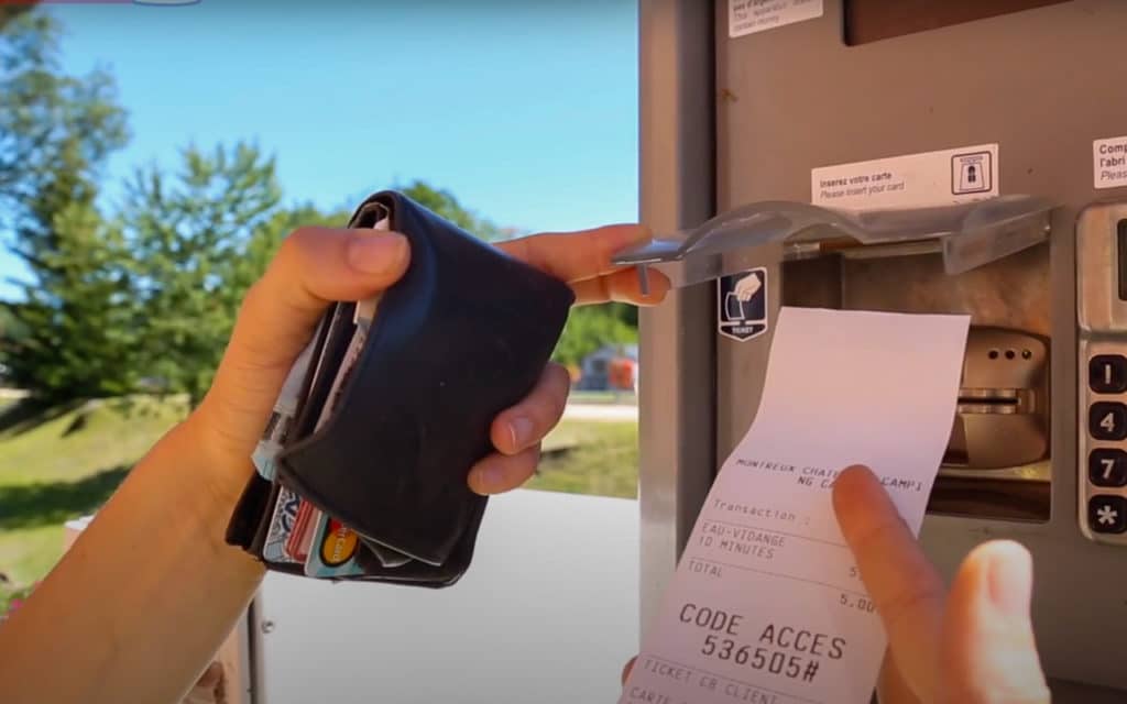 Paying at a motorhome service point terminal in France with a bank card and receipt