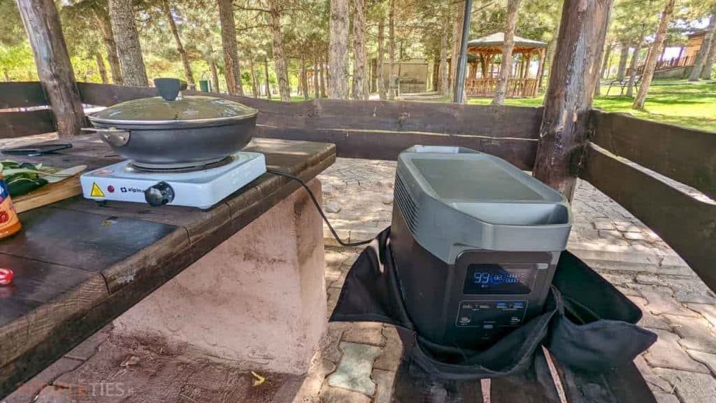EcoFlow Delta power station running an electric hotplate in a campsite shelter