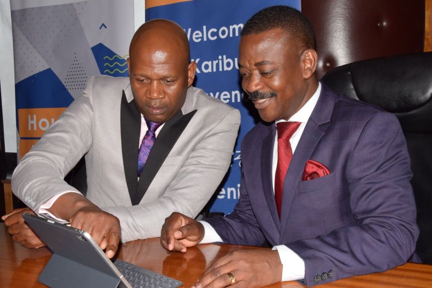 Shelter Afrique Managing Director Andrew Chimphondah (left) explains financials results to Shelter Afrique Chairman Nghidinua