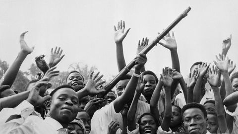 01 Jul 1960, Leopoldville, Congo --- 7/1/1960-Leopoldville, Congo-A group of Congolese wave guns, whoop and shout for joy dur