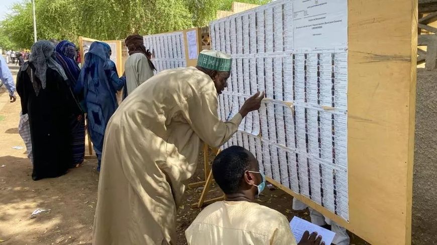 Des électeurs tchadiens cherchant leurs noms dans les registres d'un centre de vote pour la présidentielle à Ndjamena, le 11 