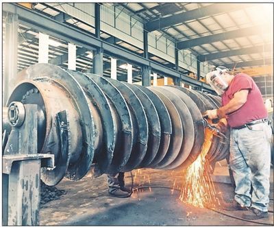Workers of Birtley Industrial Equipment Corporation, the first China-invested company in Kentucky, are welding equipment. (By