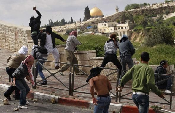 Des manifestants palestiniens lancent des pierres aux policiers israéliens à Jerusalem est, le 16 mars 2010. DAN BALILTY/AP/S