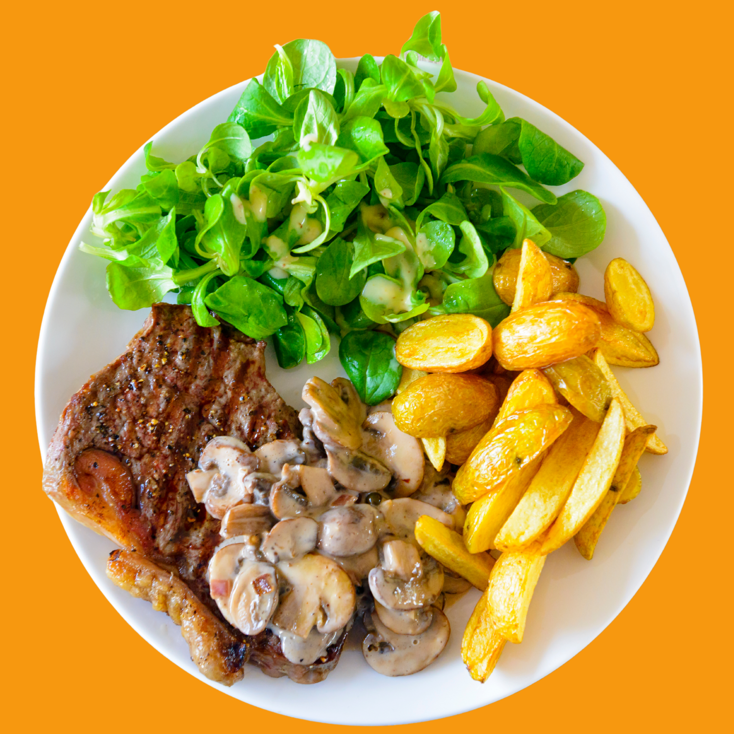 Plate with steak, mushrooms, roasted potatoes and salad greens.
