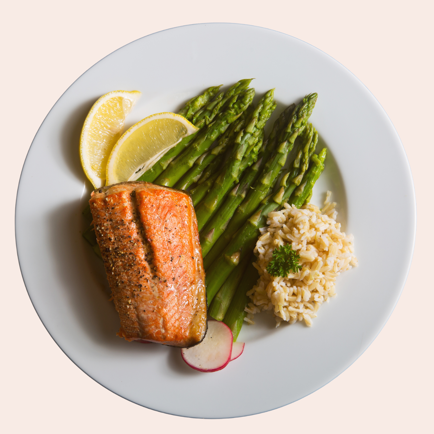 Plate containing salmon, brown rice and asparagus.