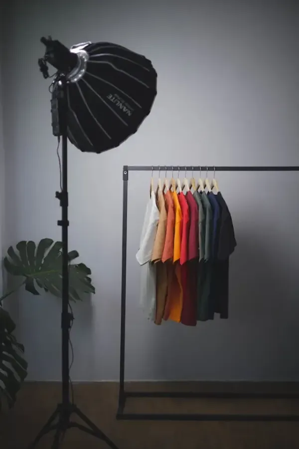 Custom t-shirts hanging on a clothing rack, illustrating a successful merchandise line created using free design tools.