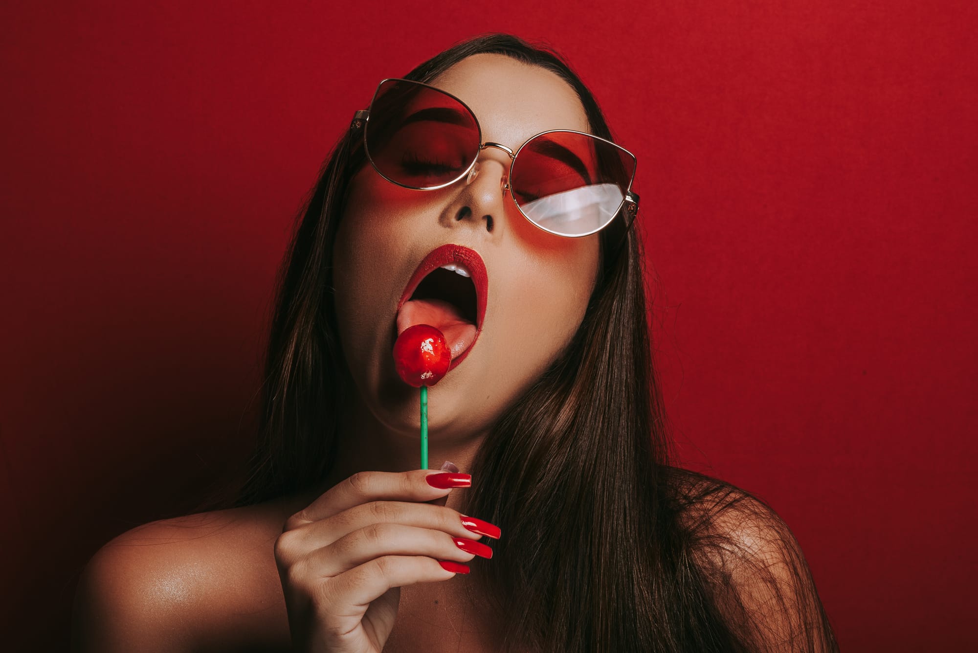 Sexy woman licking lollipop