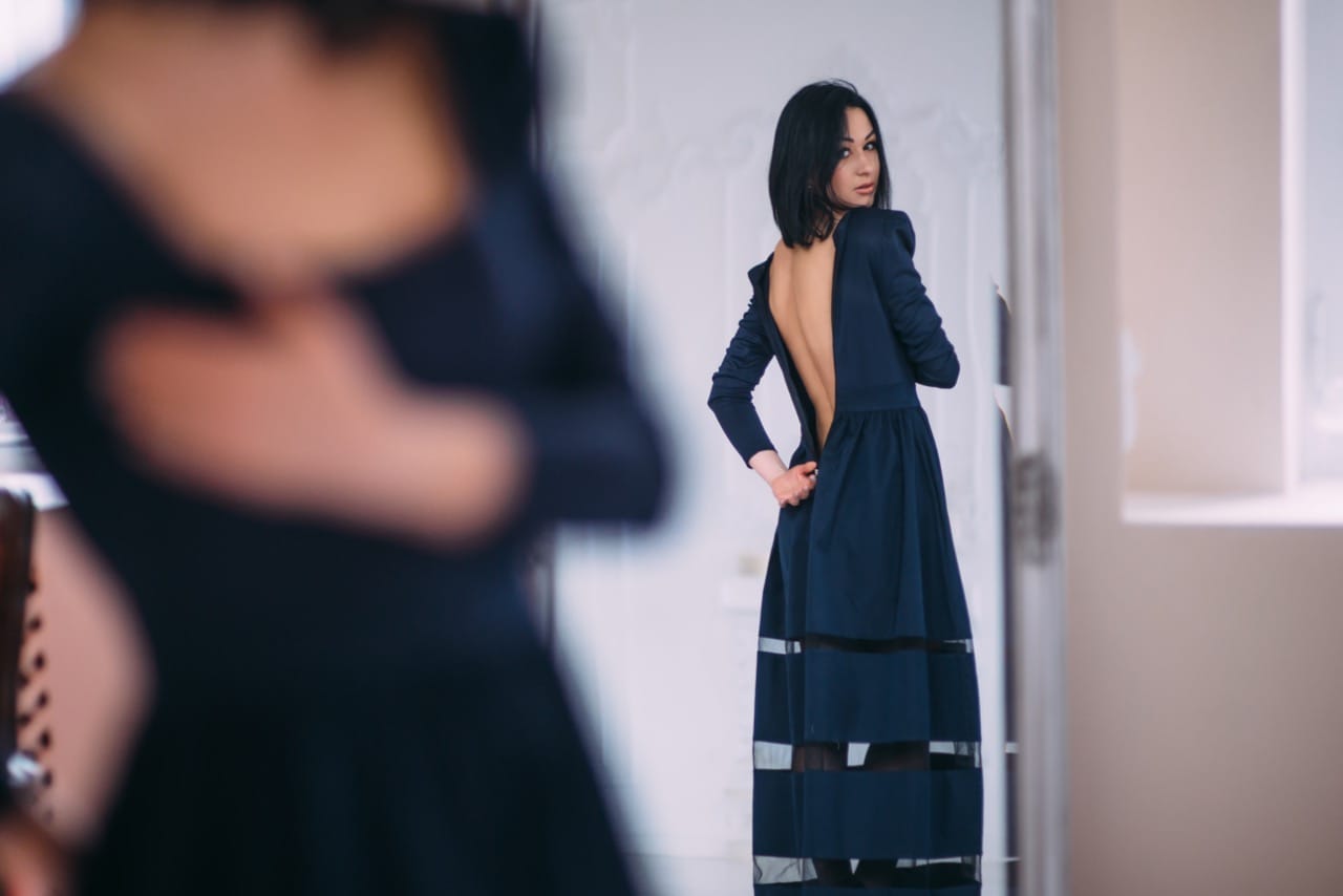 woman undressing in front of the mirror