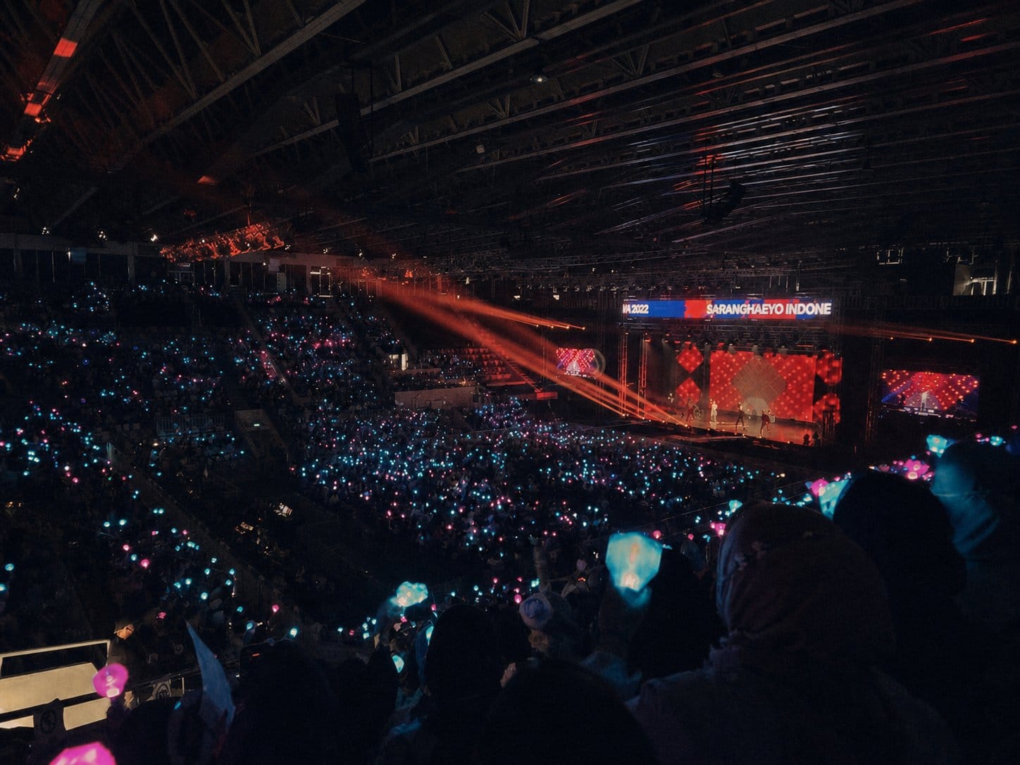 fan crowd with lightsticks inside concert hall