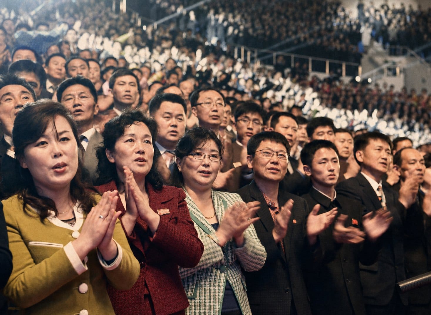 Korean listeners aged 40-60 at indoor concert