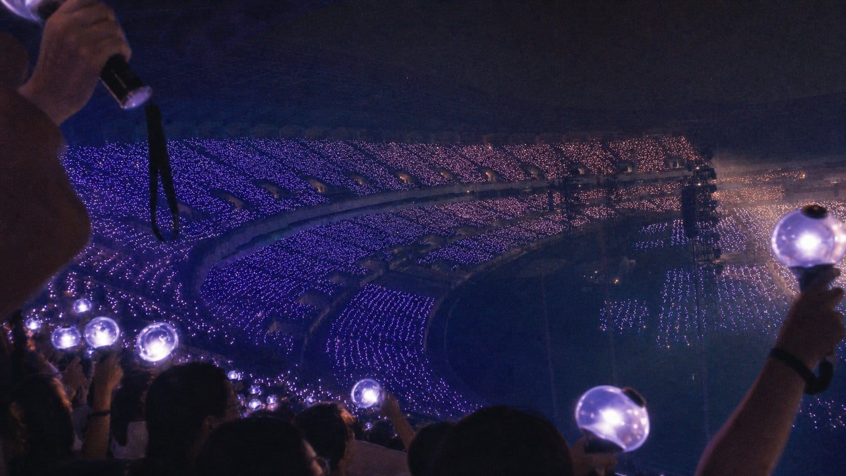 K-pop fan crowd with lightsticks