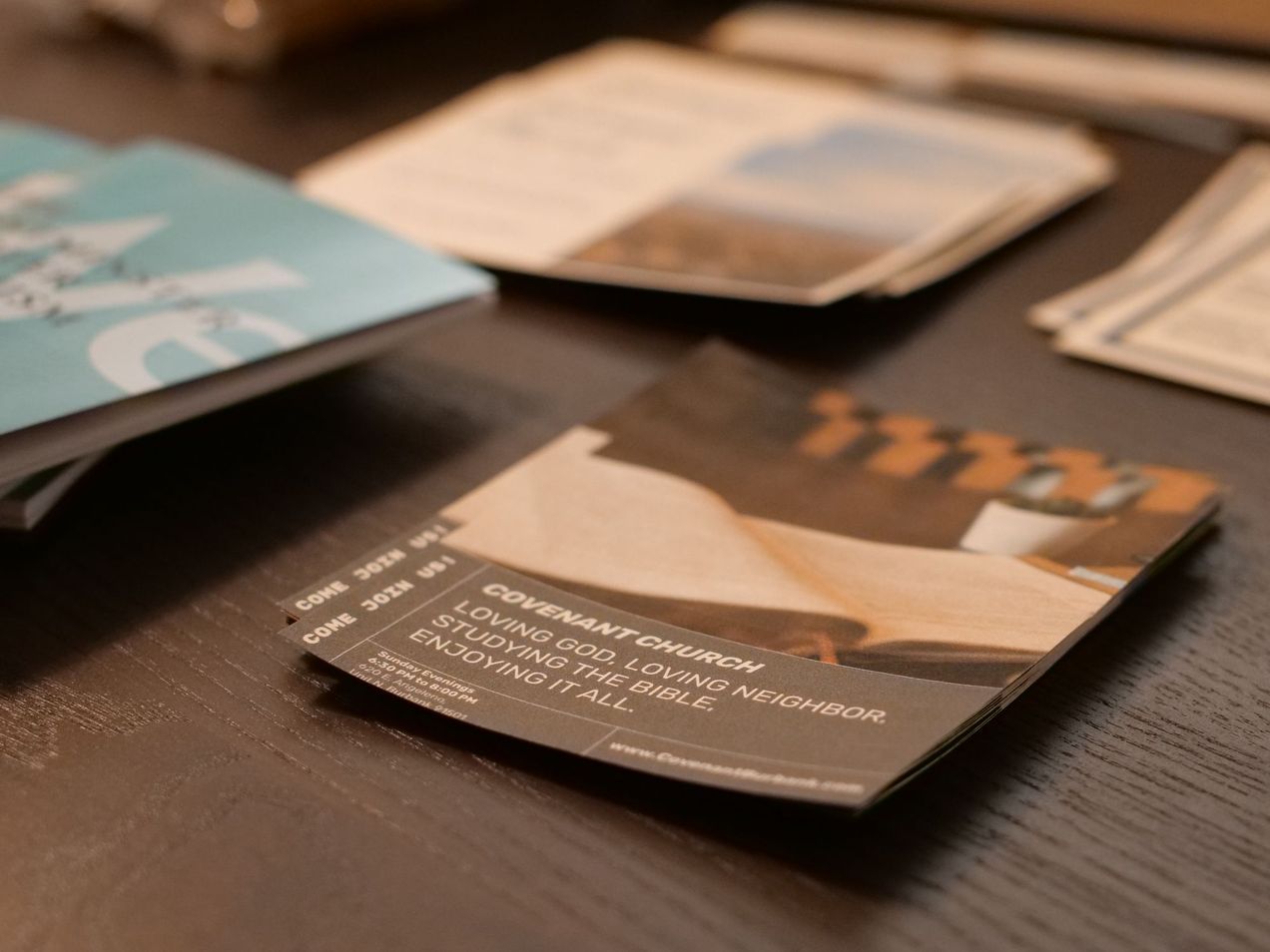 Various church flyers and info booklets on a table
