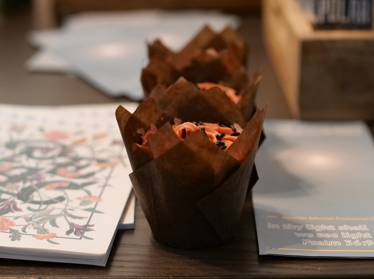 Strawberry cupcakes, Tabletalk magazine, and an Associate Reformed Presbyterian Church denominational flyer.