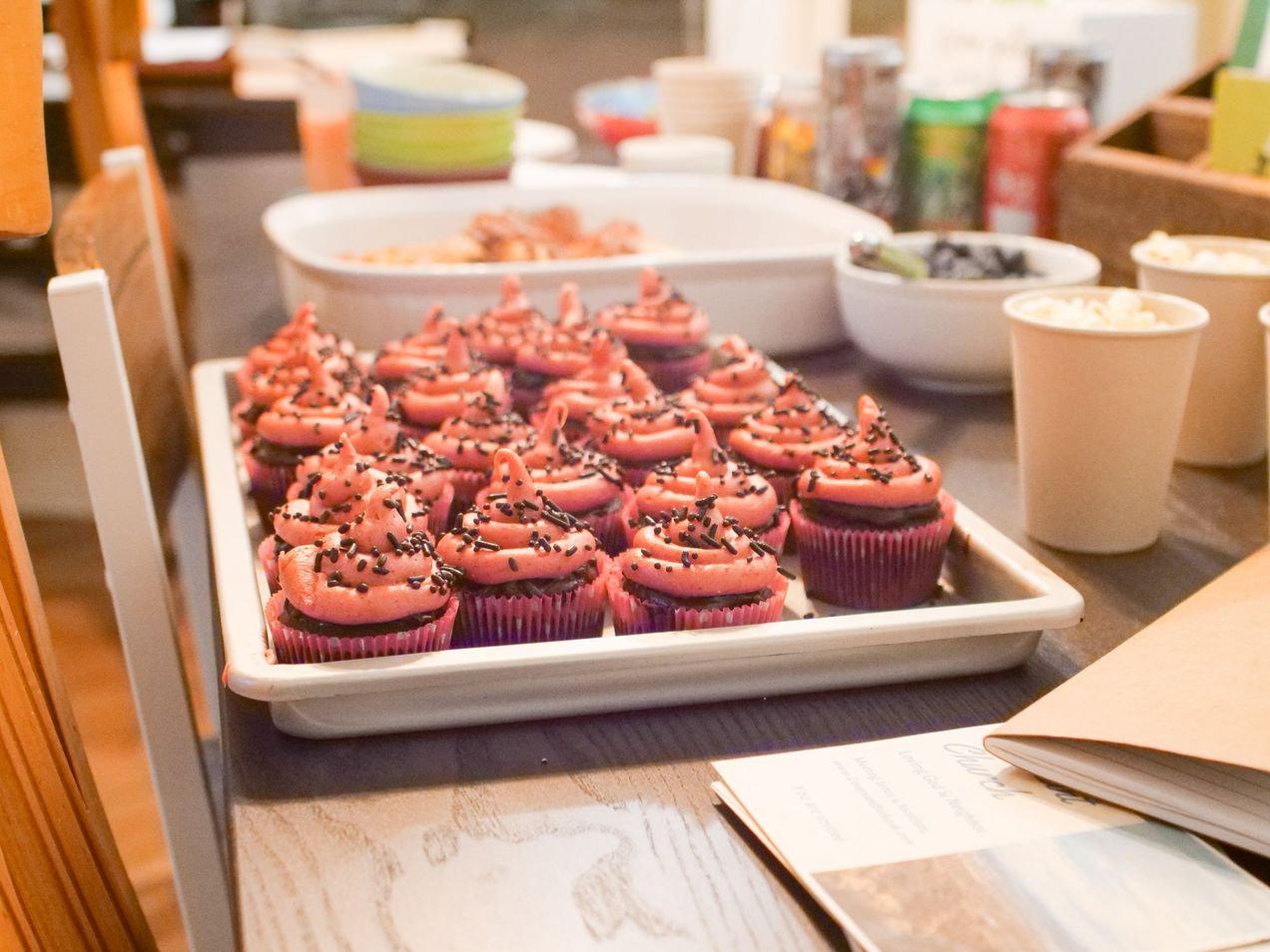 Table with Strawberry Cupcakes, Popcorn, Blueberries, Pizza, and Other Snacks at the Covenant Church Evening Meeting