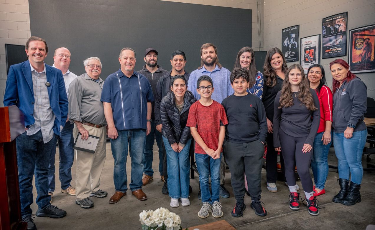 People standing together for a photo, some of the first members of Covenant Church, a Reformed church plant