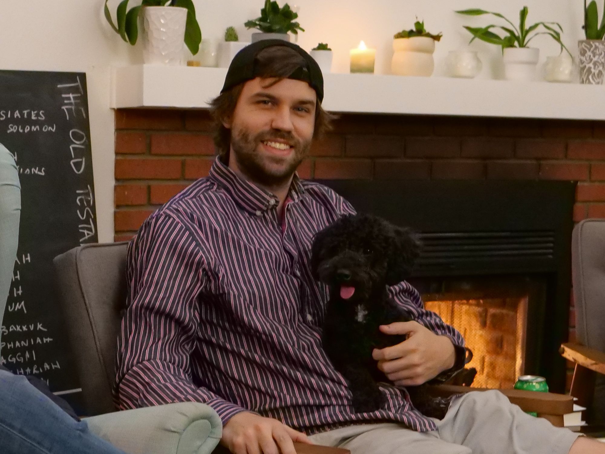 Man and puppy in front of a fireplace at the Covenant Church meeting
