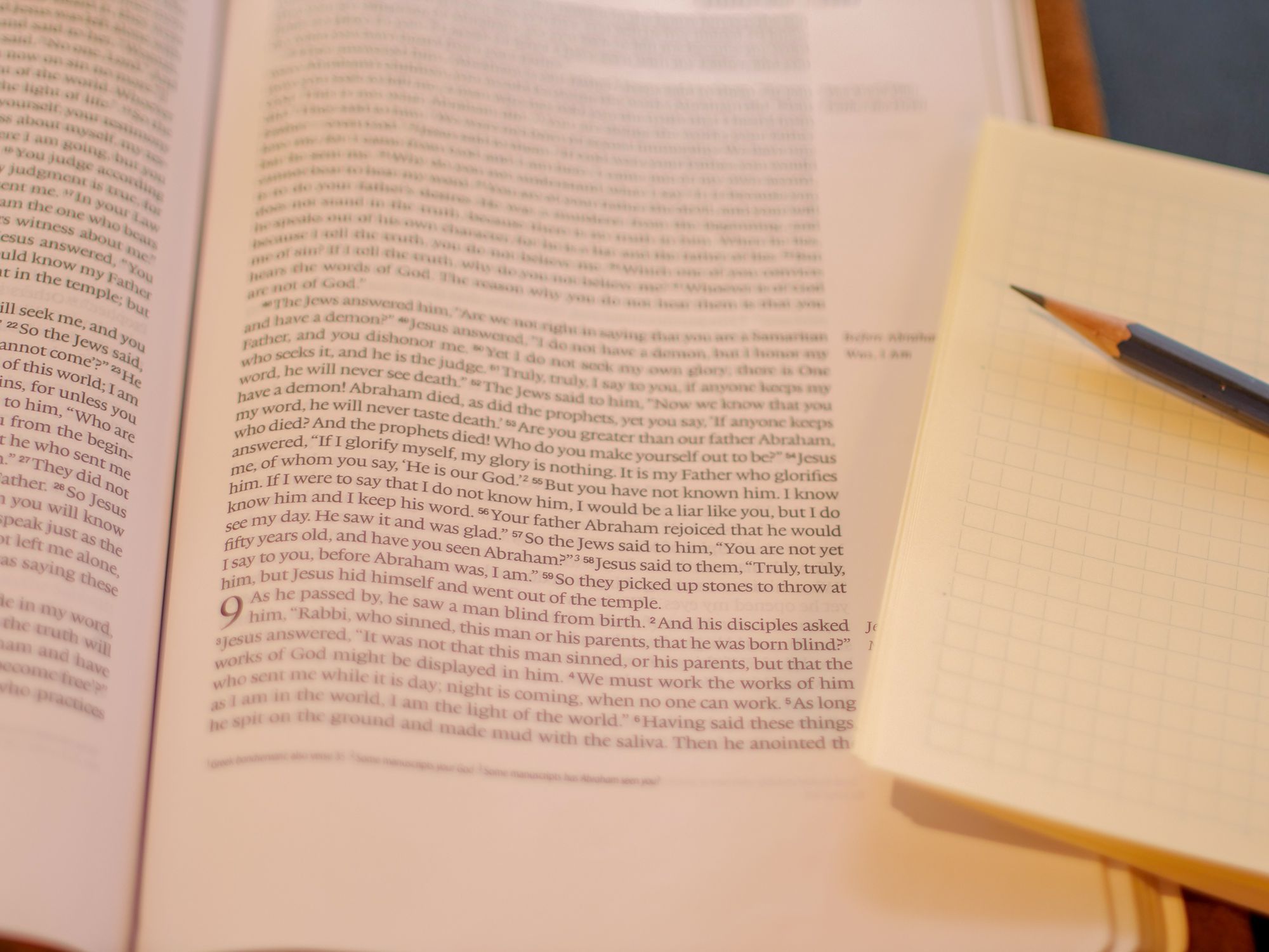 Bible, notebook, and sharpened pencil