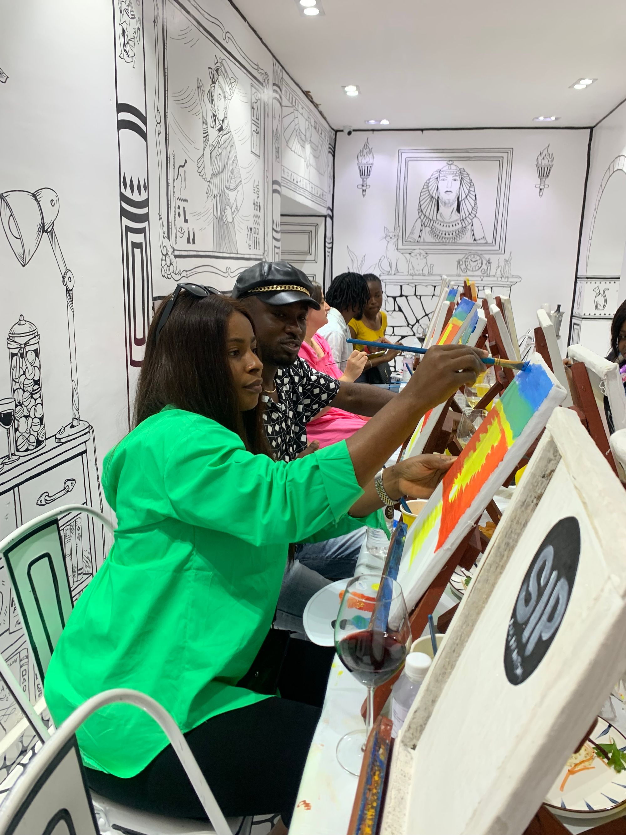 A couple painting at a Sip and Paint NG session