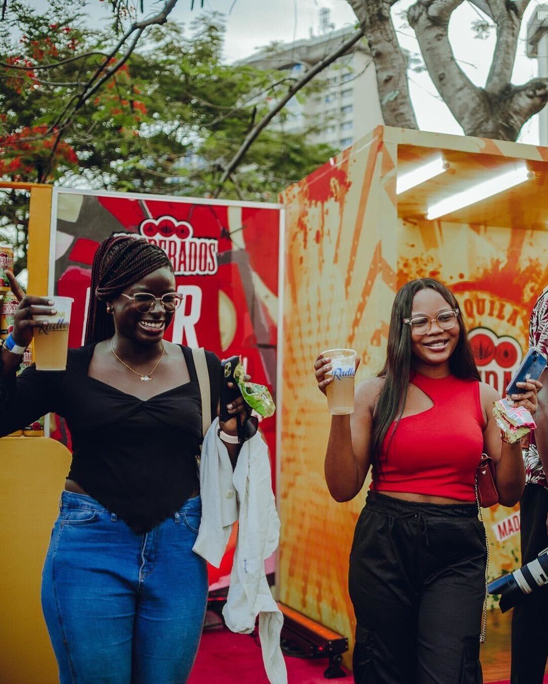 Attendees at the Movie in the Park Experience posing with cups of Star Radler