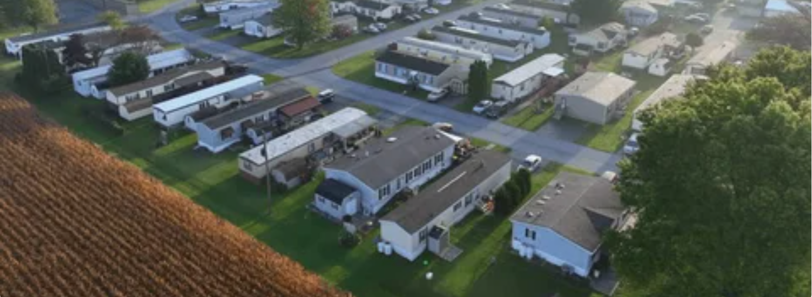 image from above, a group of trailer homes near farmland