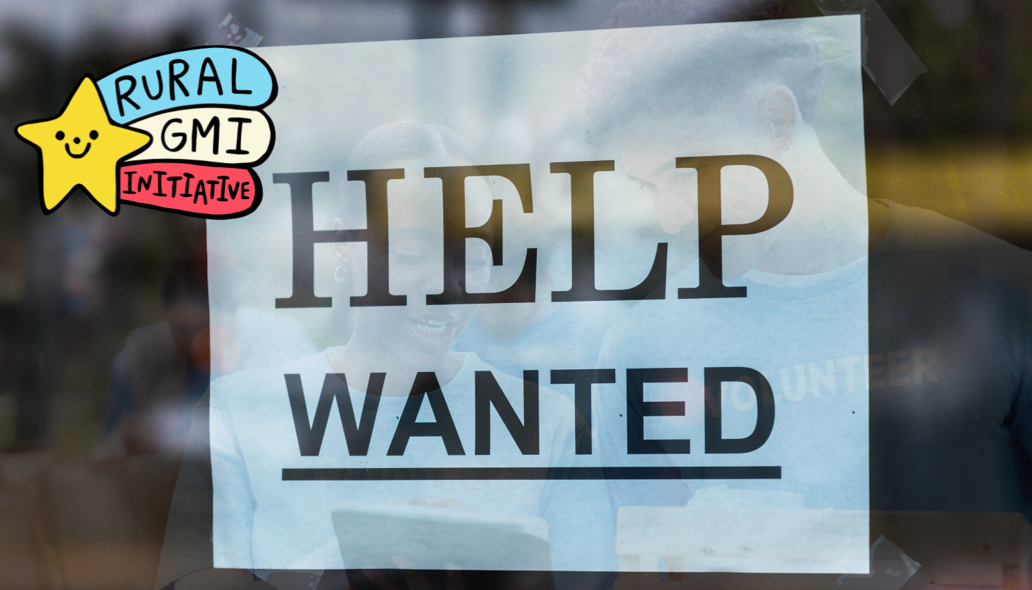 A photo of a help wanted sign taped to a window.  In the reflection of the window are two volunteers, working together.  The RGMII logo is included in the image.