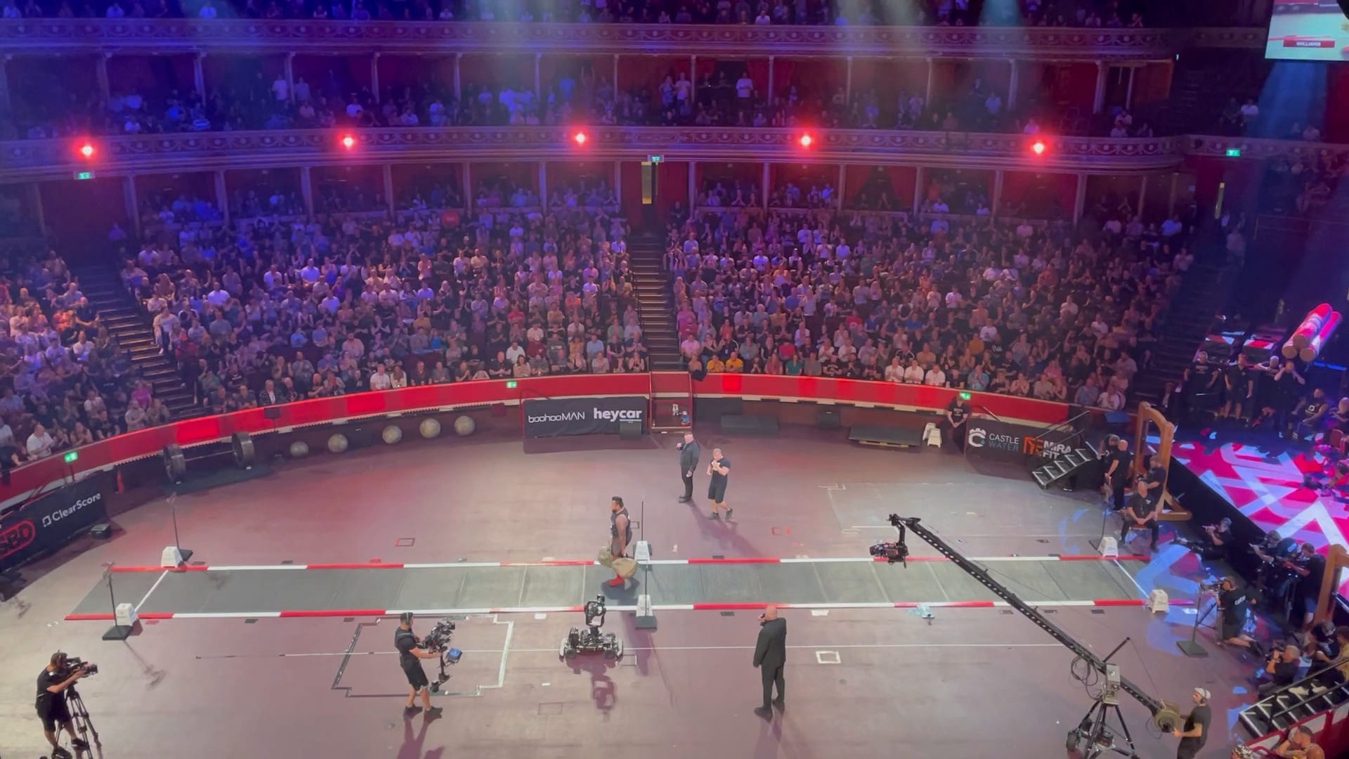 A photo of Eddie Williams carrying the Nicol Walking Stones at the Strongman Classic.