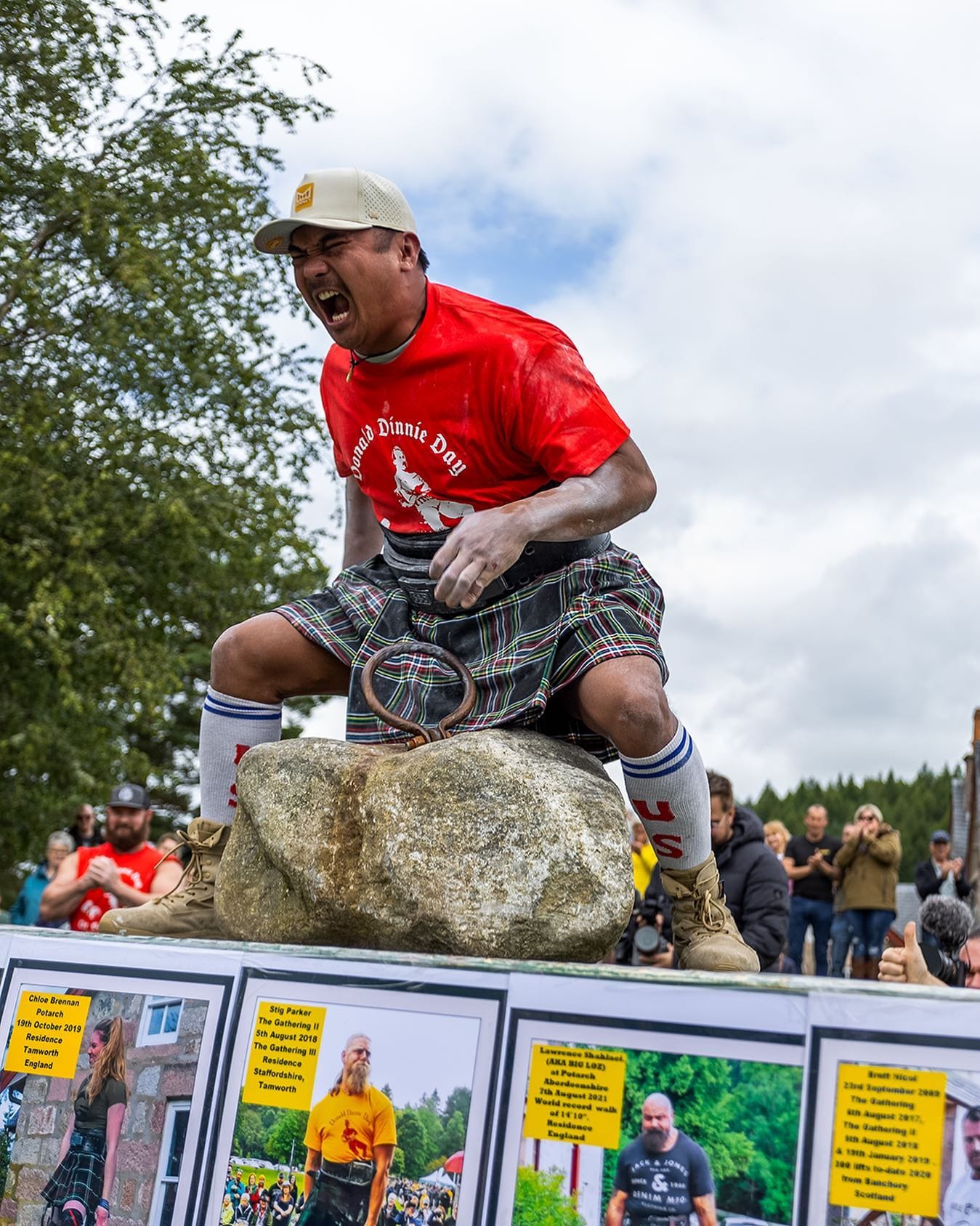 Romark Weiss screams in celebration after lifting the Dinnie Stones.
