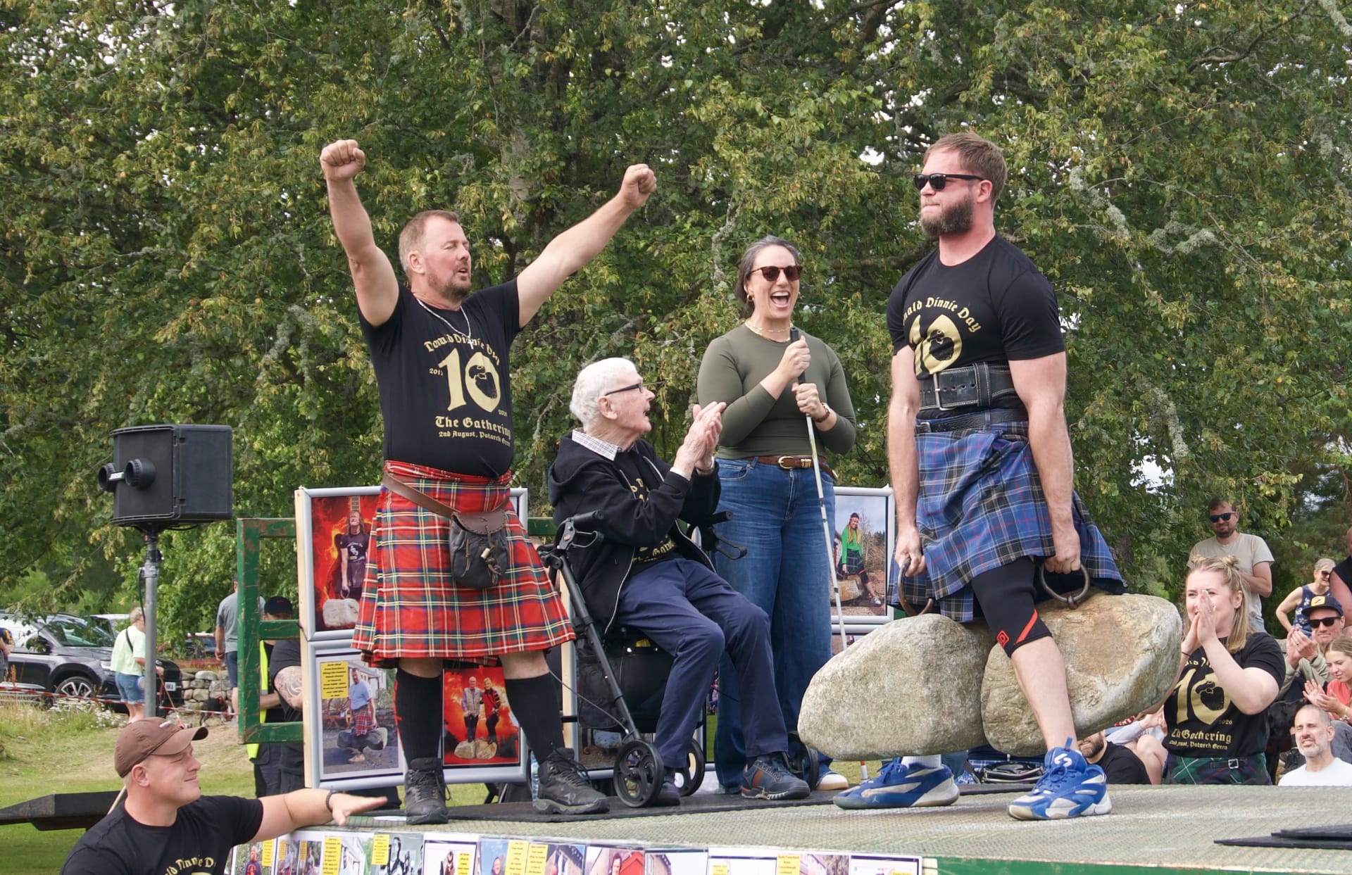 A partially blind man lifts the Dinnie Stones on stage at Donald Dinnie Day 2026.