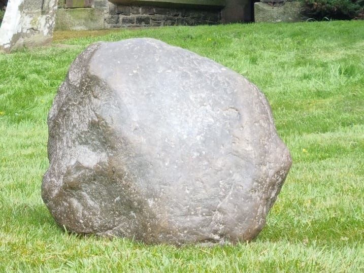 The Maegen Stone sitting on grass.