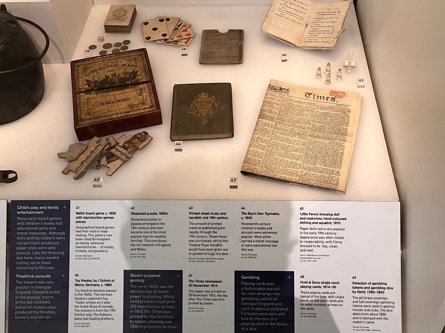 A collection of things from the early 1800s. Included among these are "Wallis' board game" from 1826, and a set of playing cards.