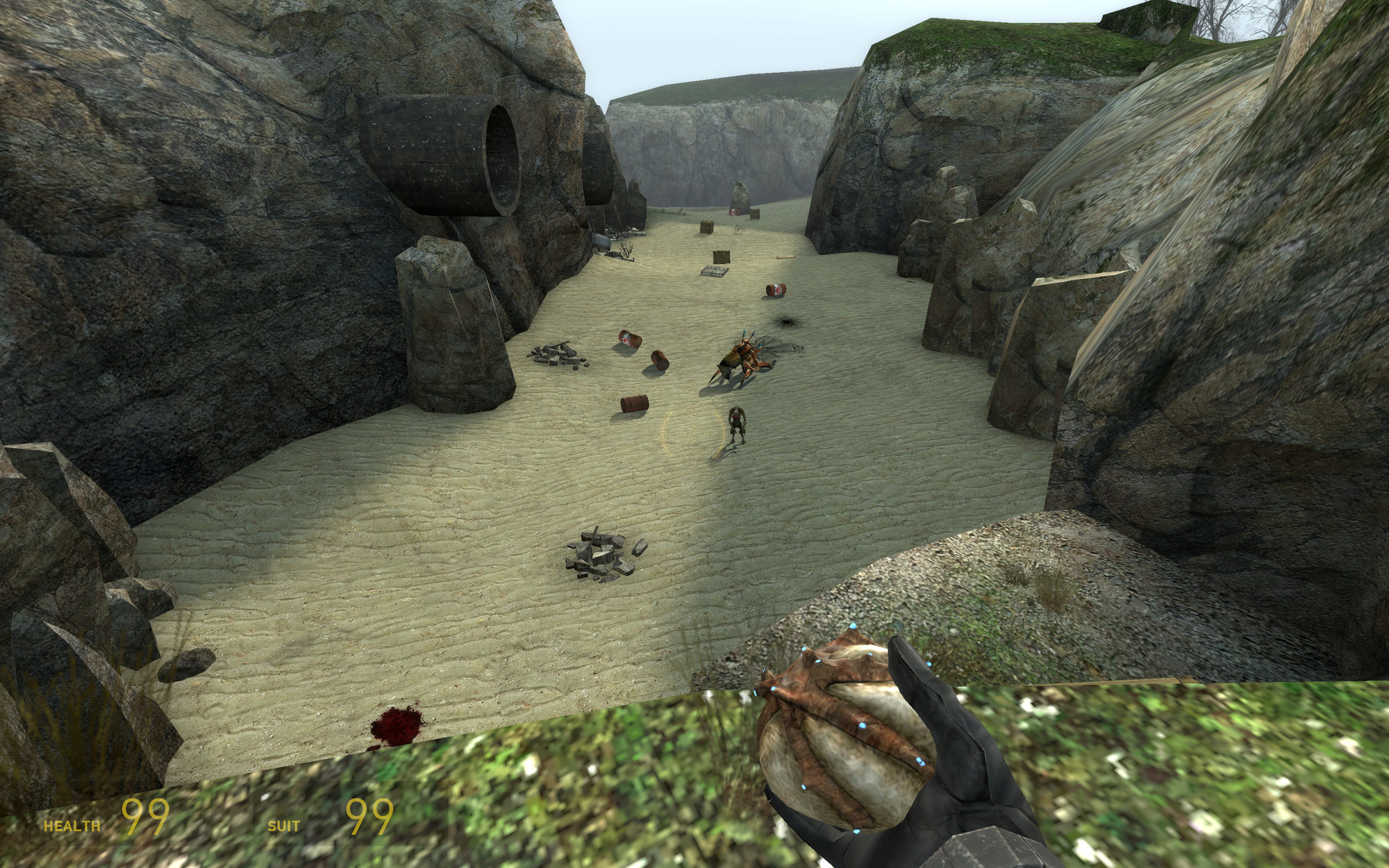 Me looking below from a cliff in Sandtraps, which after you go down from to defeat an Antlion Guard you aren't supposed to go back up. The Antlion Guard is dead and there is a Vortigaunt waiting for me to come back down again. Also I have exactly 99 health and suit energy.