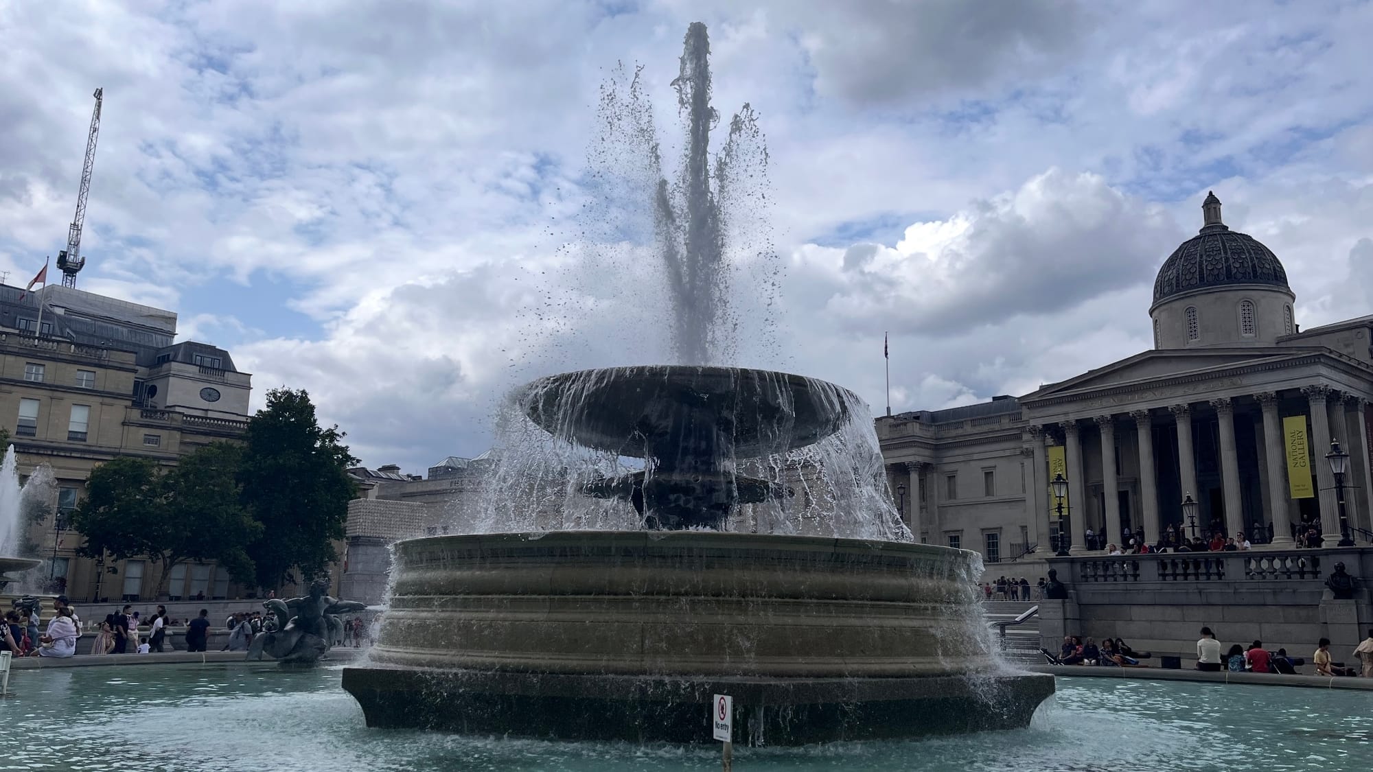 The westmost fountain on Trafalgar Square, spewing water.