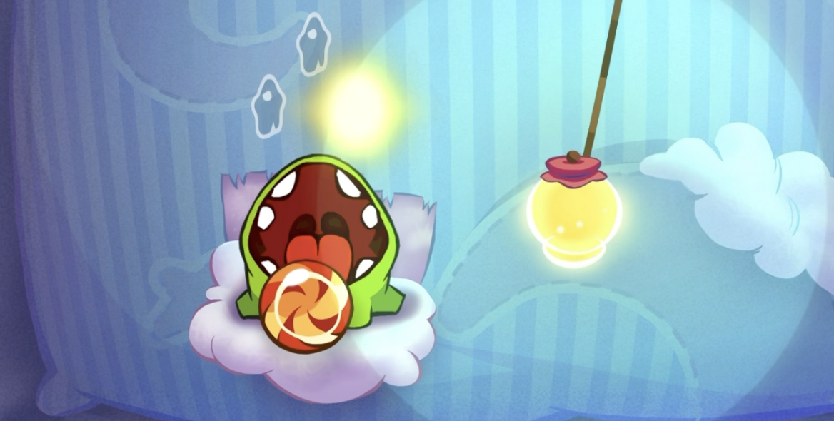 A screenshot from Level 16-1 from Cut The Rope. The lantern woke up Om Nom just in time for him to eat the candy, which is close to falling off the stage.