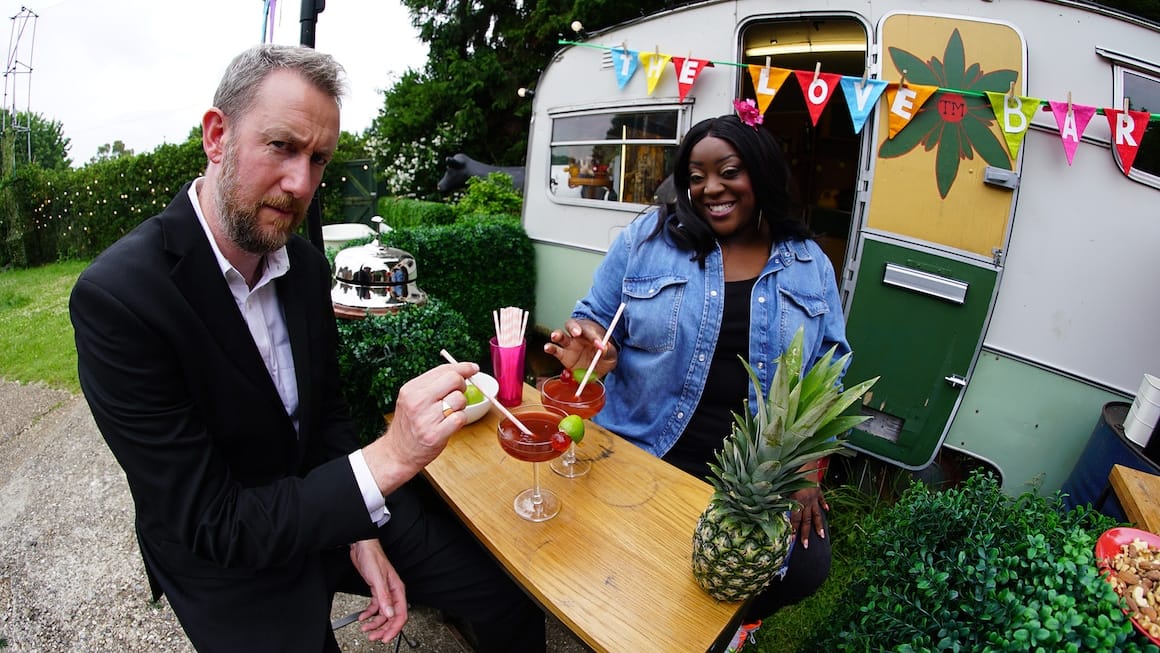 Screenshot of Taskmaster UK S13 E6. Judi Love and Alex Horne are holding cocktails which Judi made in a cement mixer.