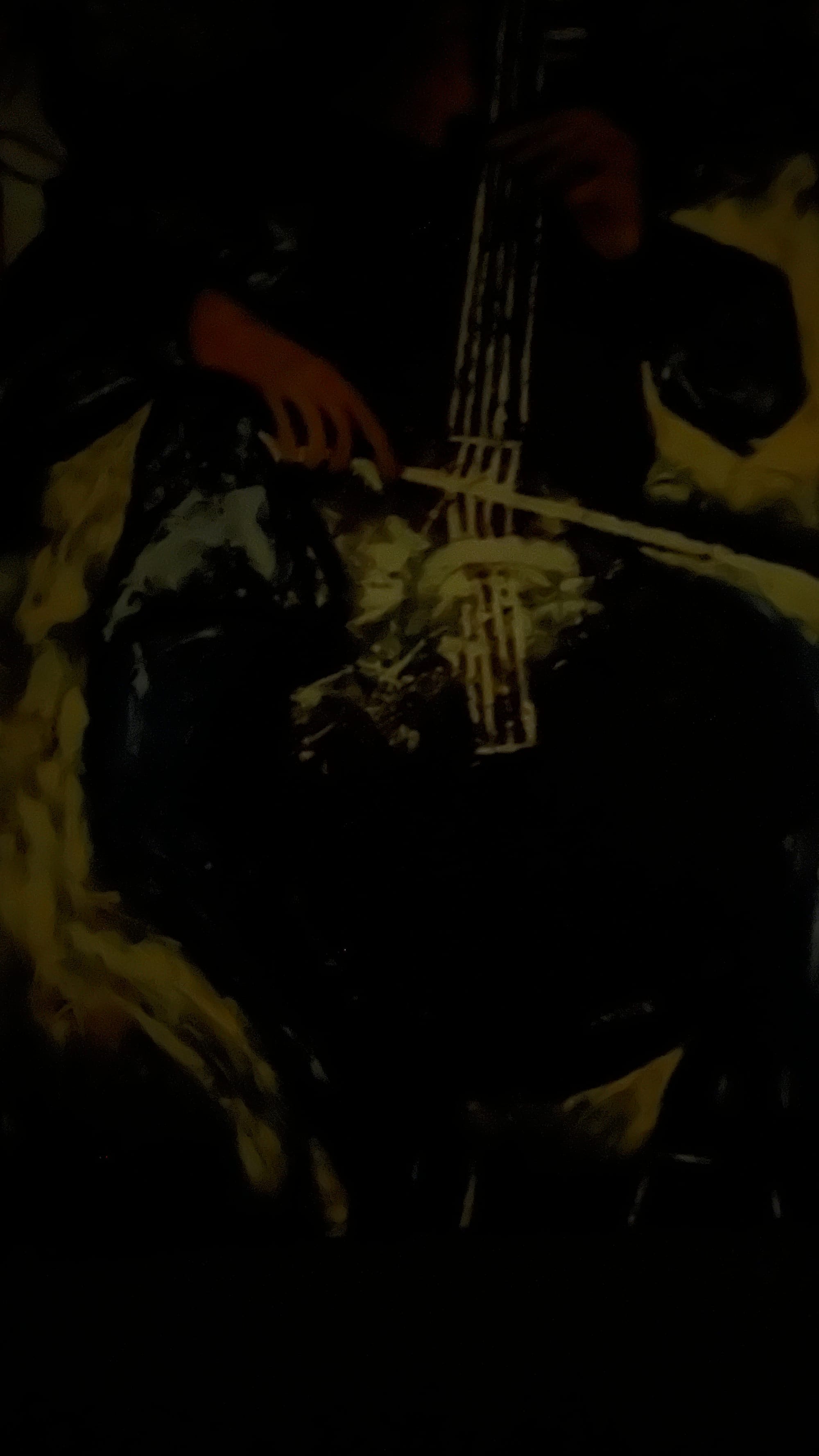 The same painting but in a dark room taken with high exposure. The entire thing is much darker, almost all black except some large spots of yellow, and small spots of green and red.