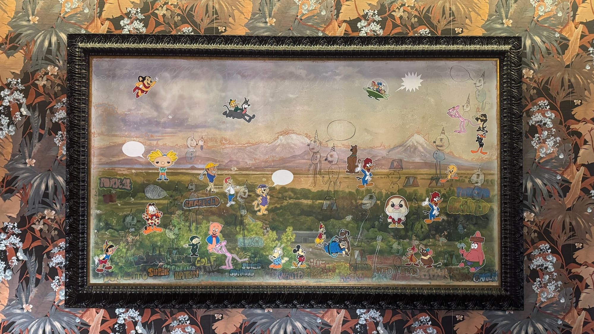 A painting by Armando Romero, dated 2022. It's a landscape painting that has seemingly been painted over with crayons, graffiti, and stickers, but they are all actually paint!