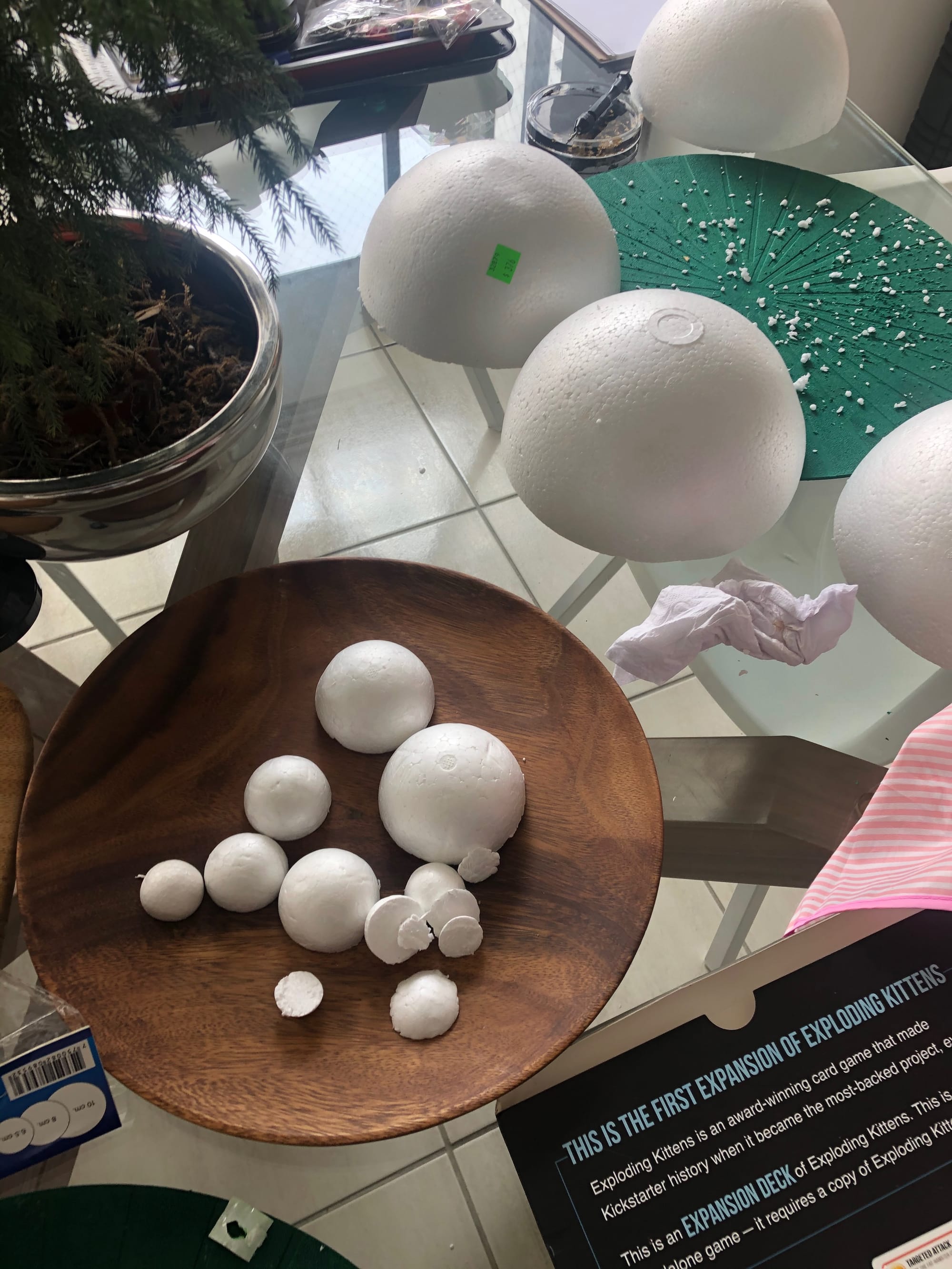 A bunch of styrofoam spheres of varying sizes cut in half. Styrofoam shrapnel is covering a part of the table.