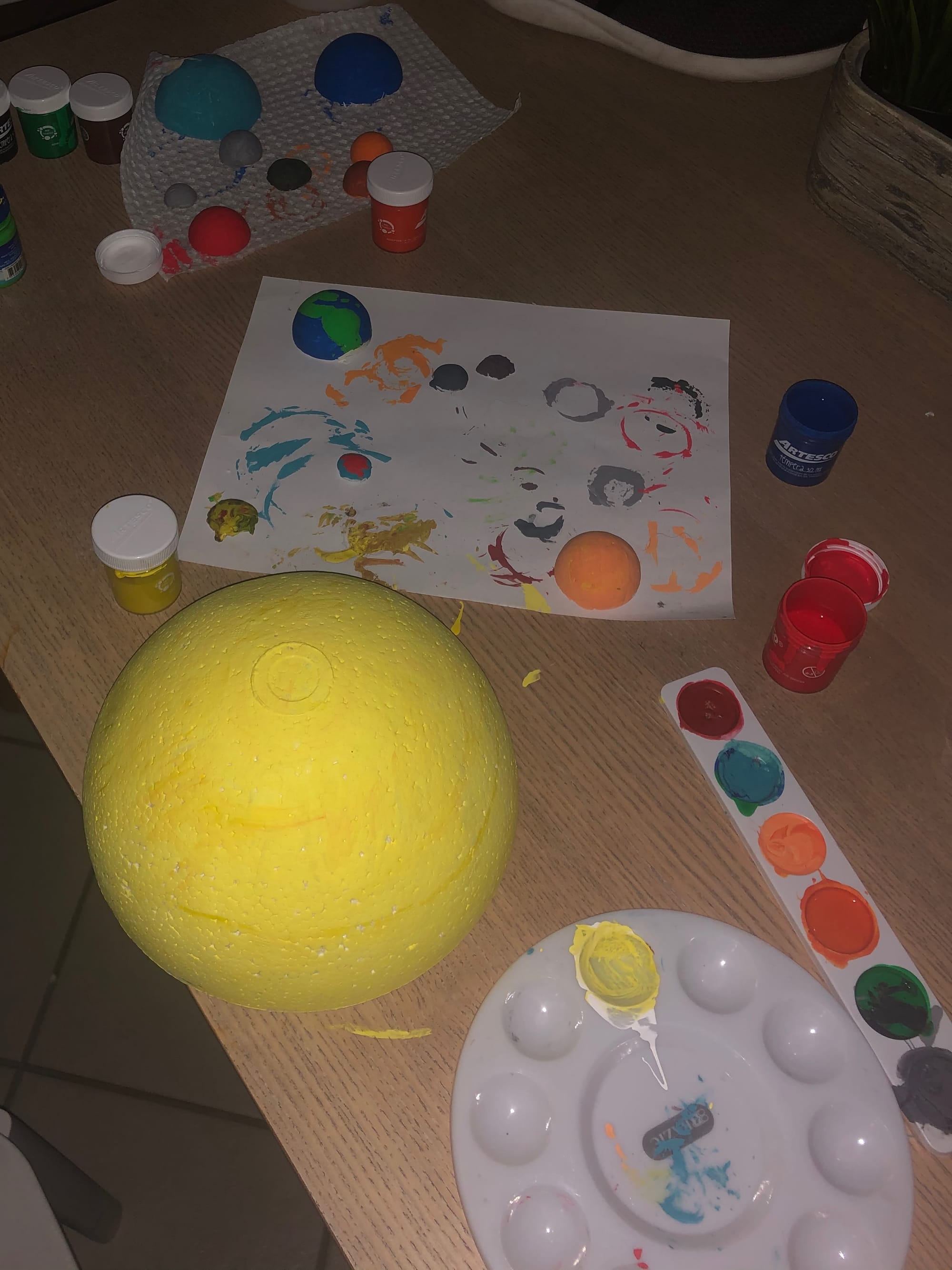 Some more finished spheres from the Solar System model. I added details to Earth, painted Pluto, Triton, Europa, Io, and Venus, and I painted a large yellow sphere for Saturn.