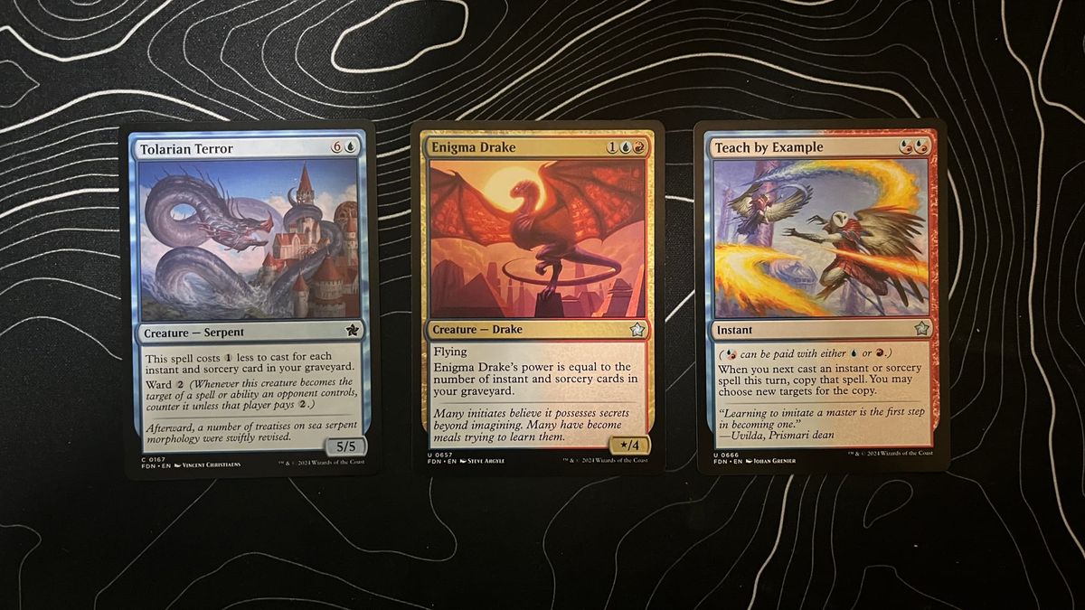 A Tolarian Terror, Enigma Drake, and Teach by Example from the Magic: The Gathering Foundations set.