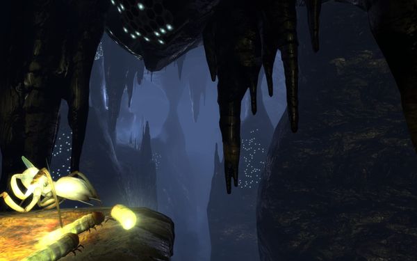 A screenshot of the main menu background of the mines (ep2_background02), featuring three grubs and an Antlion Worker at the edge of a cliff in the caves.