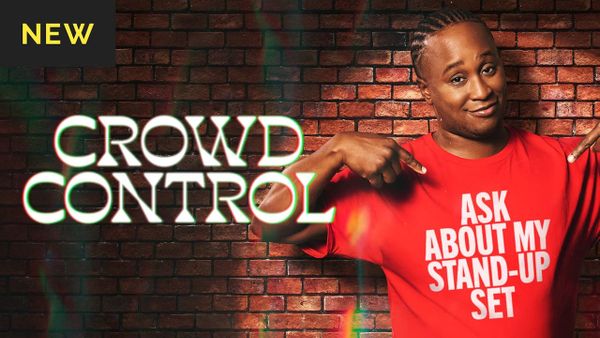 The cover for Crowd Control in dropout.tv. Host Jacquis Neal is pointing at his red shirt saying "Ask about my stand-up set" in front of a brick background.