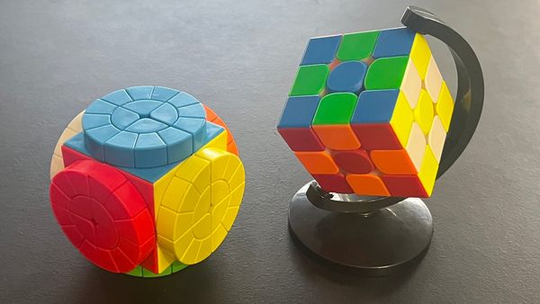A 2x2 Time Machine puzzle, and a spinning globe cube stand.